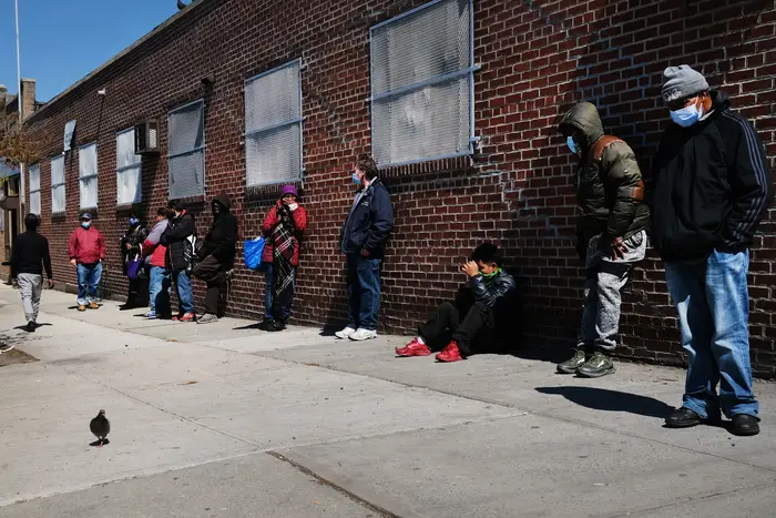A photo of people in Brooklyn waiting in line for a food bank at the height of the COVID-19 pandemic